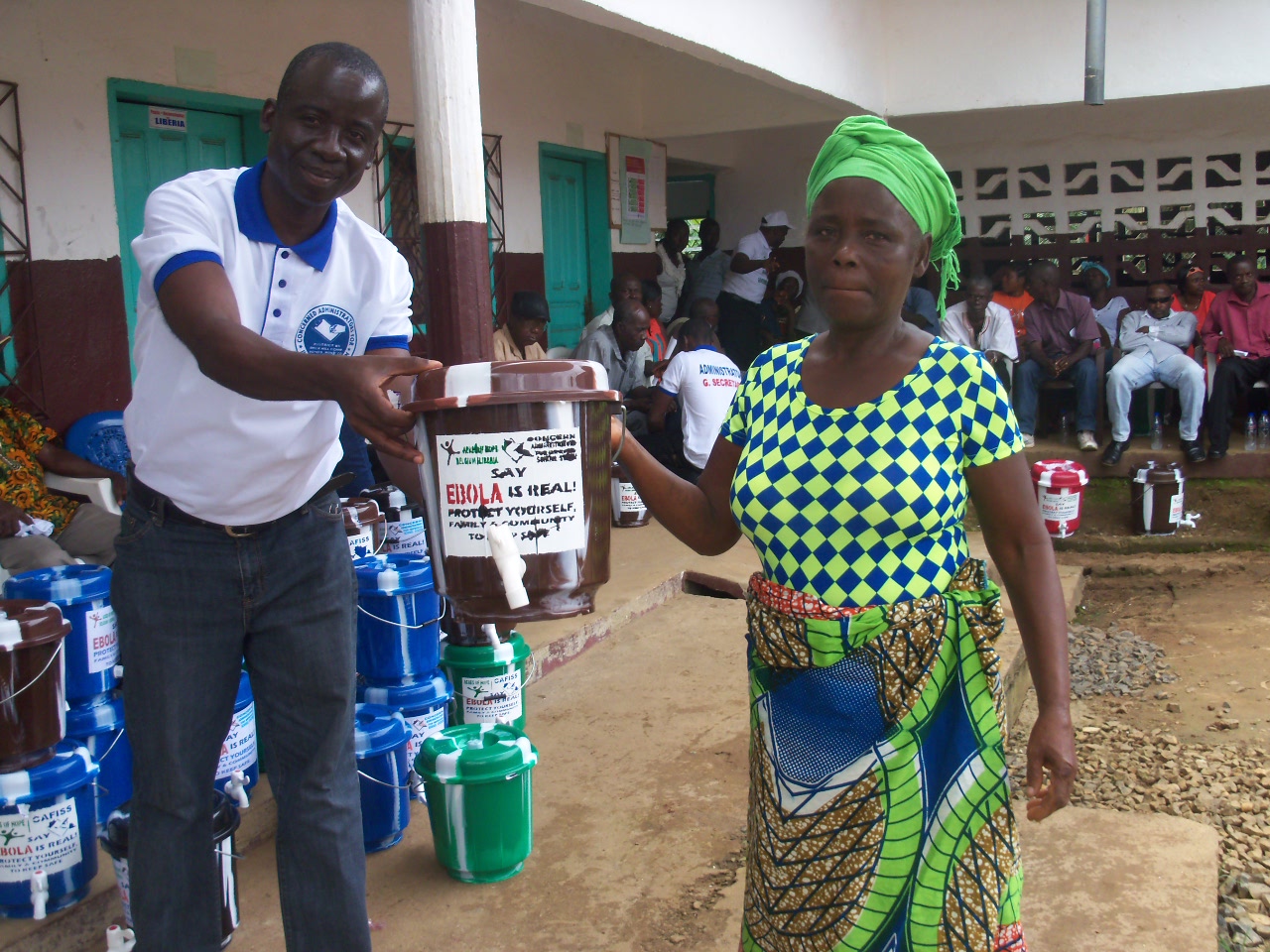 Handing out buckets with bleach for sanitizing.